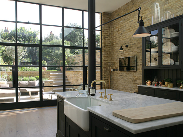 kitchen with large crittall windows looking out onto landscaped garden - grand designs - extensions