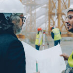 Two surveyors on a building site