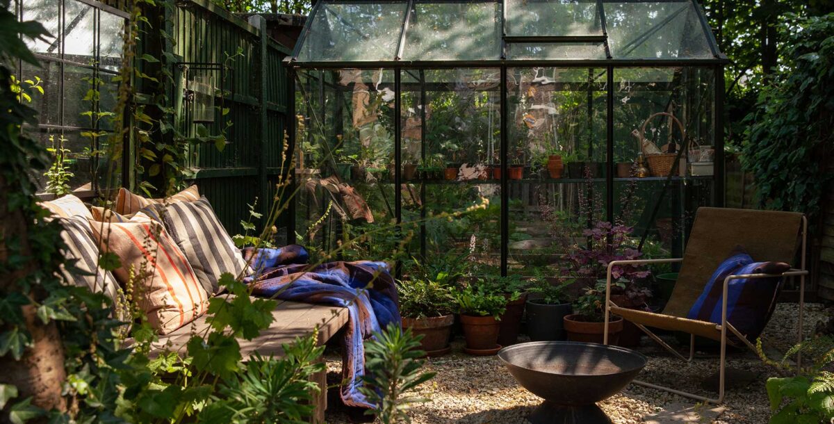 A glass conservatory works well in a small garden layout