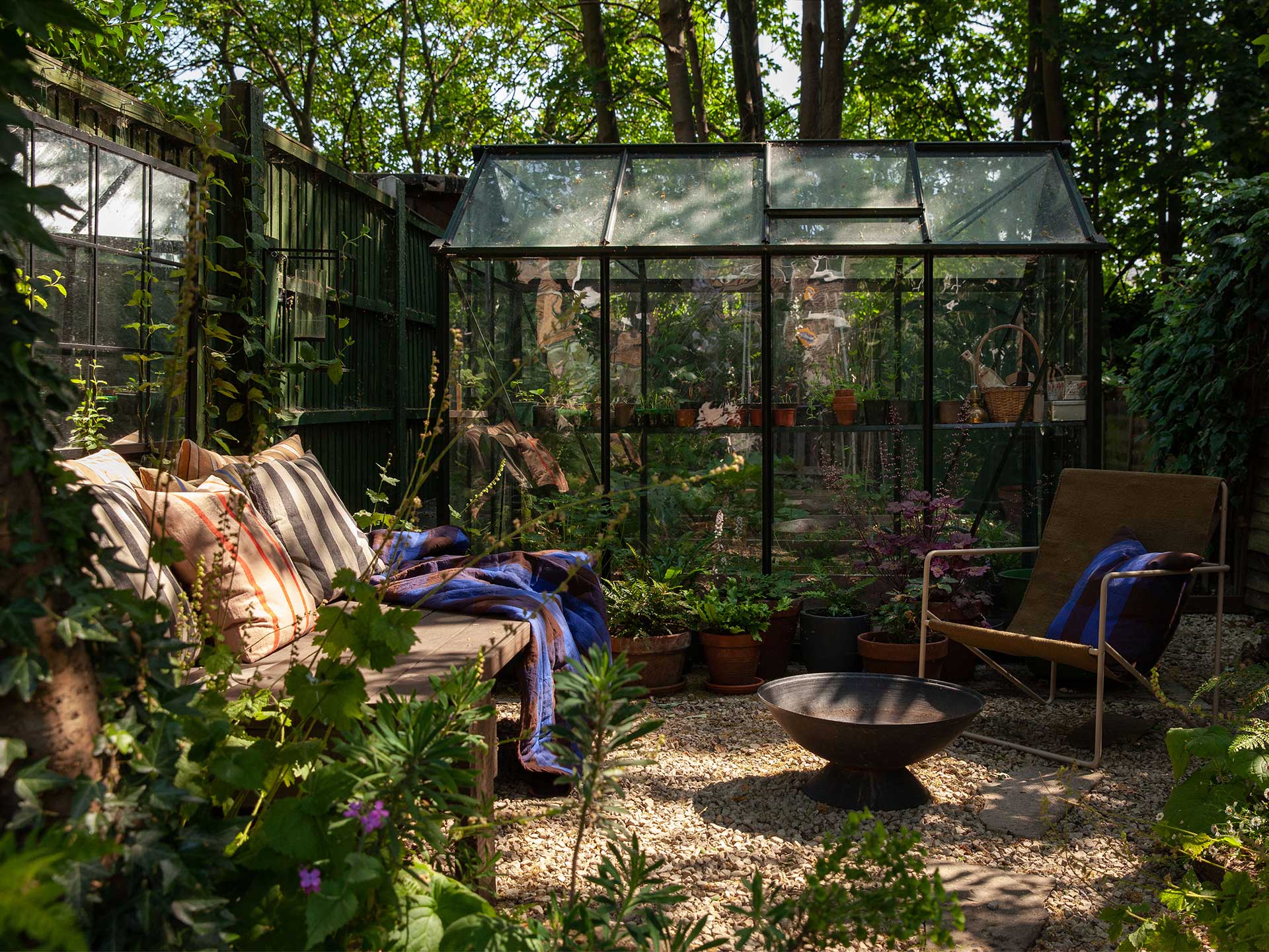 A glass conservatory works well in a small garden layout