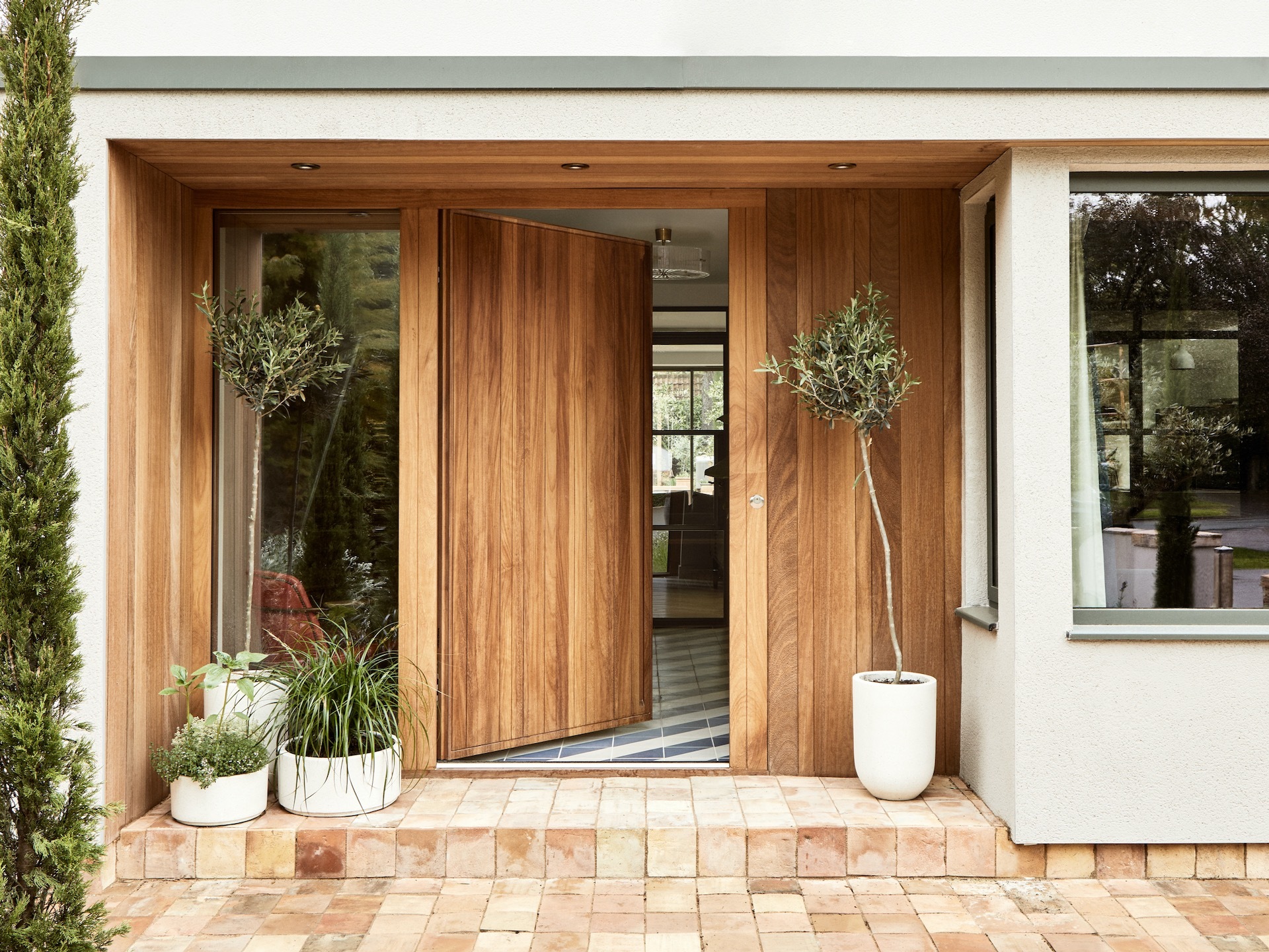 Wooden front door with wide porch