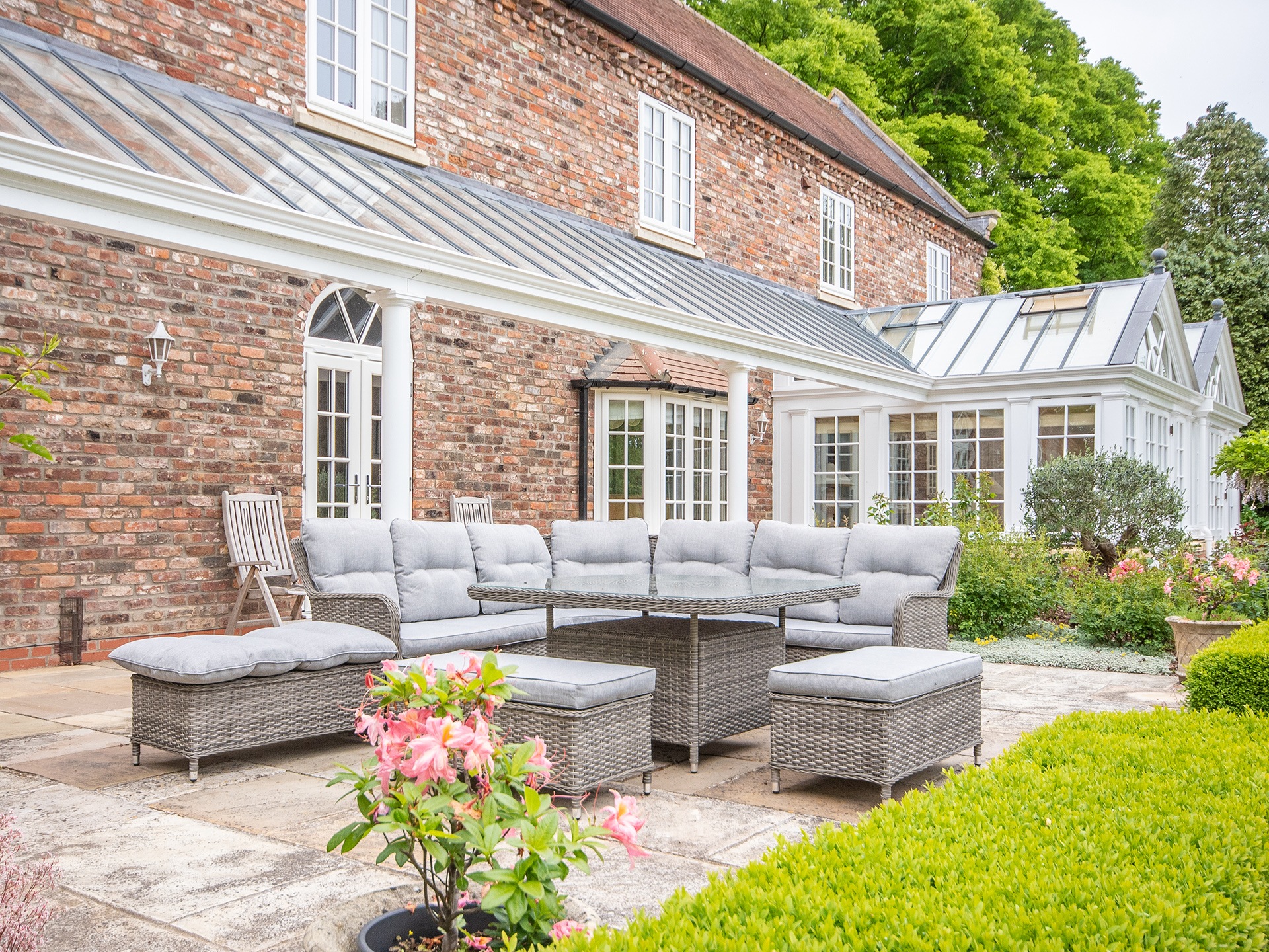 grey and white veranda with couch and plants