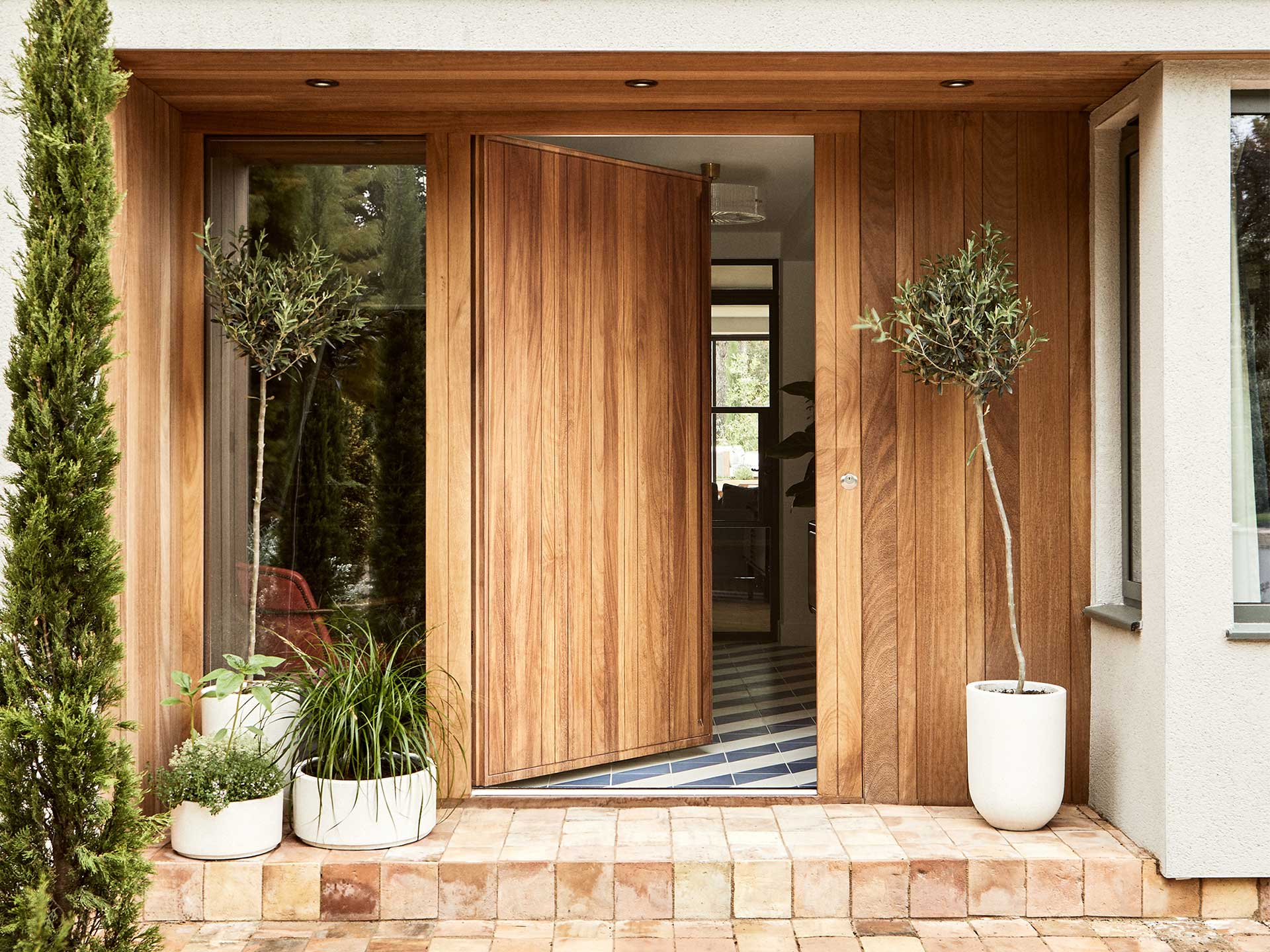 Porch ideas to add texture include using handmade tiles,porch with plants for a nice welcoming