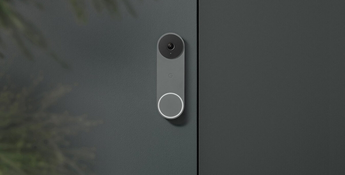 A Nest Doorbell Wired in ash, against a grey house wall