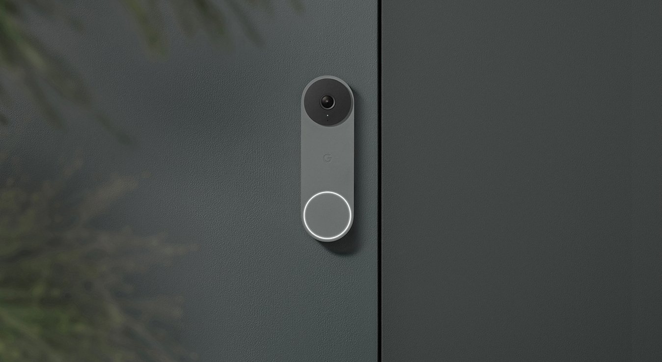 A Nest Doorbell Wired in ash, against a grey house wall