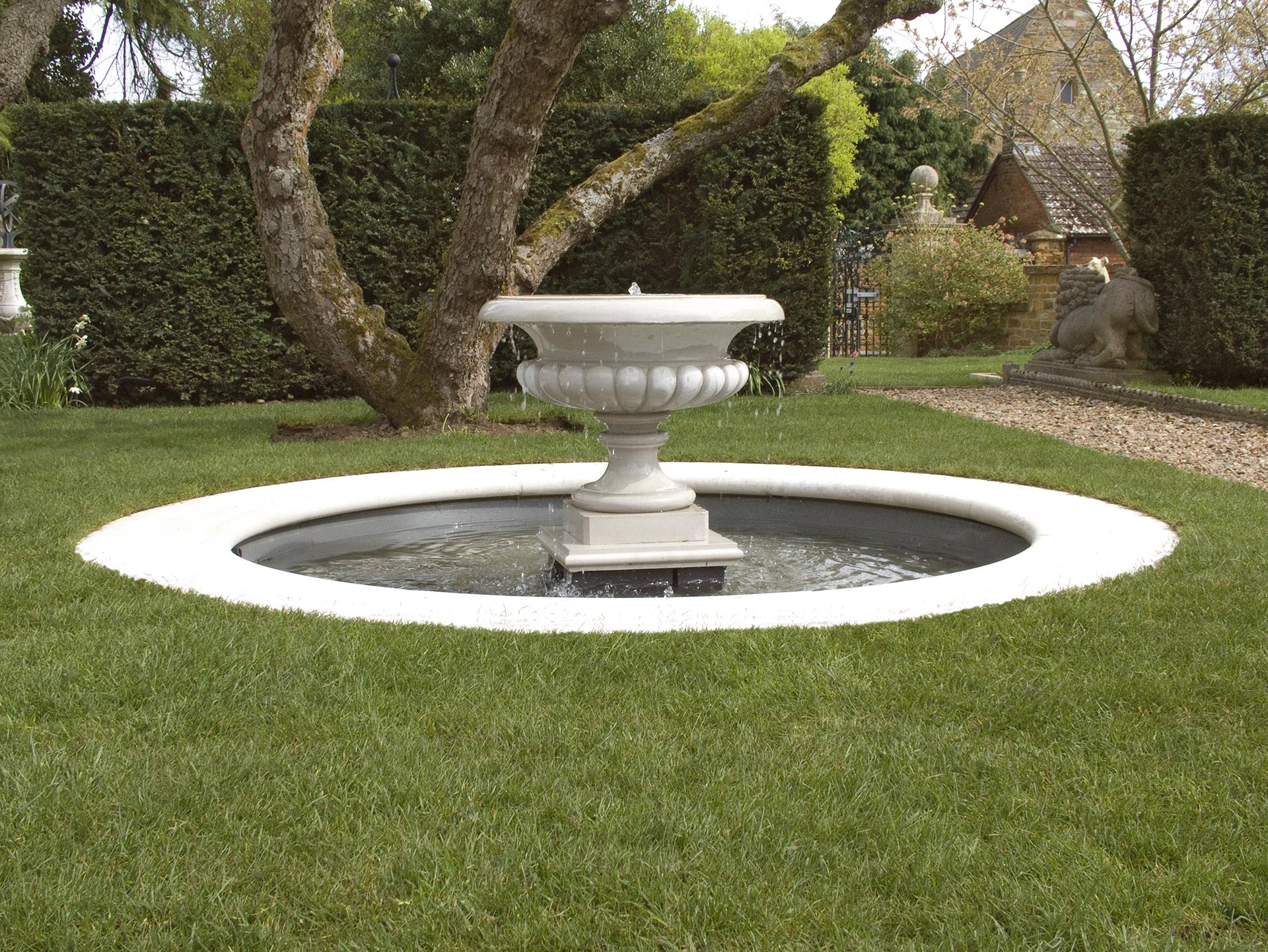 posh,modern pool/fountain around grass