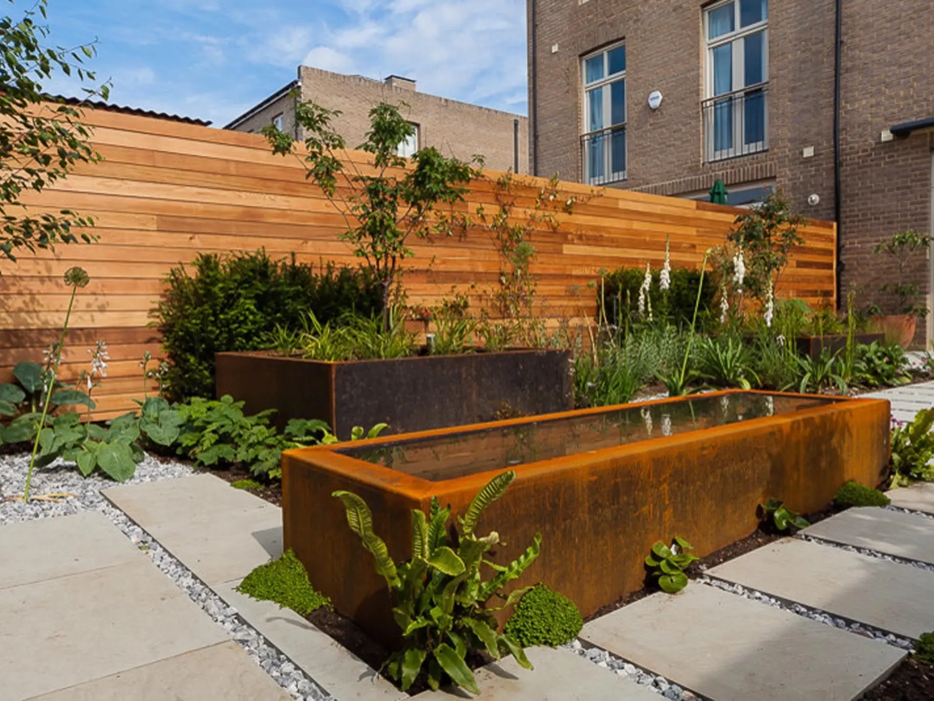 wooden fence with tiny pond and plants