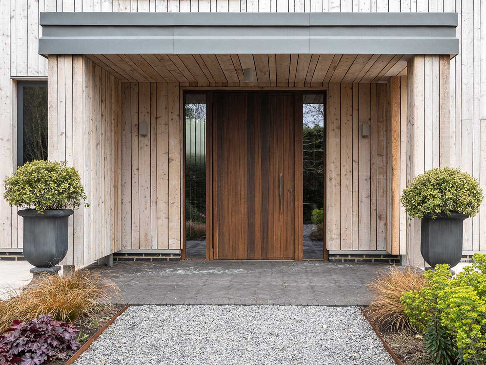 A built in porch with an overhang and side lights