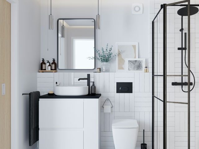 Small bathroom with white vanity unit and countertop basin, WC and black-frame shower enclosure