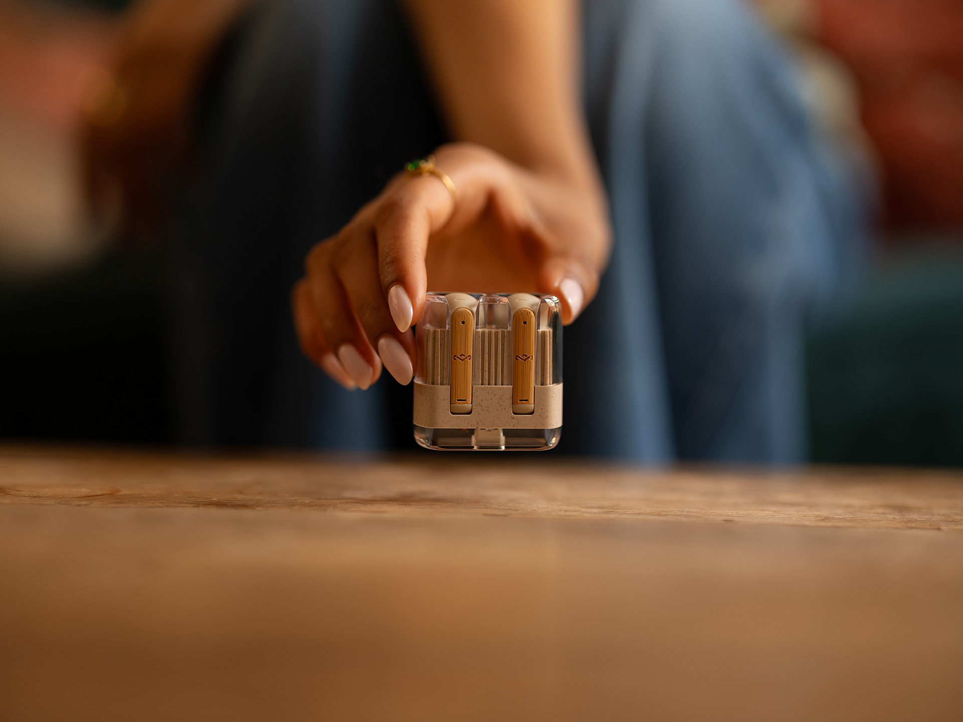 Girl holding a pair of sustainable airbuds in their case