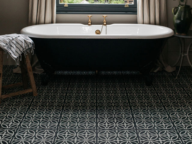 A bathroom with luxury vinyl tile flooring with encaustic tiles-style pattern