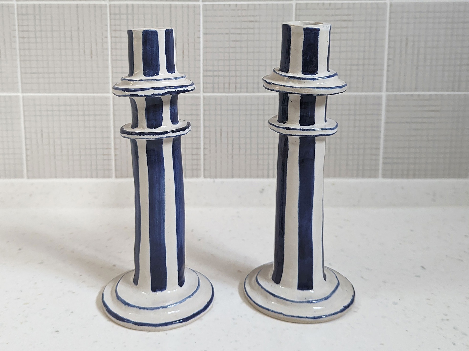 a pair of striped handmade candles