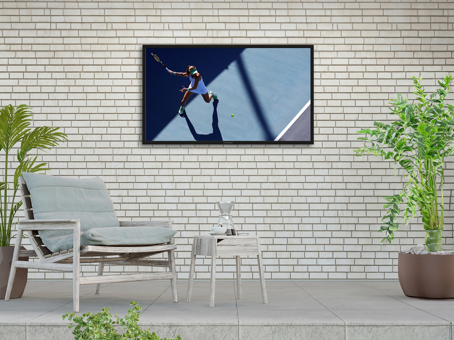 An outdoor TV on a wall next to a patio