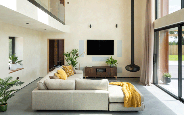 Double-height living room with a woodburning stove in one corner