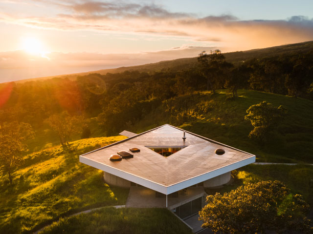 Overhead view of a detached house in the grasslands of New Zealand with solar panels to one side