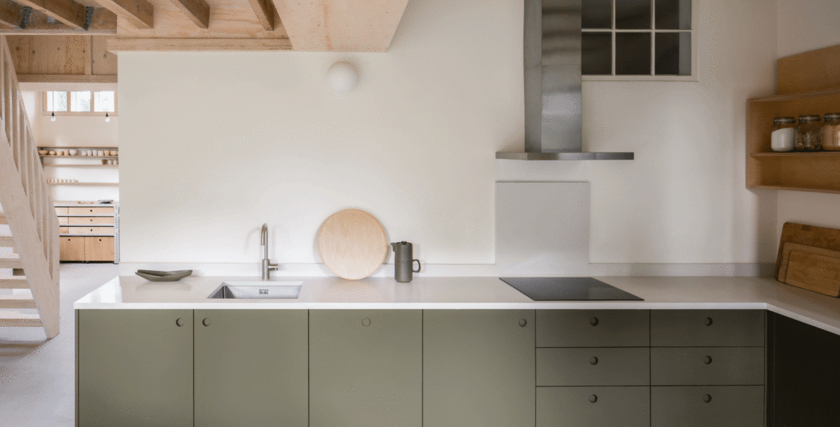 Kitchen with L-shape layout and sage green cabinet fronts