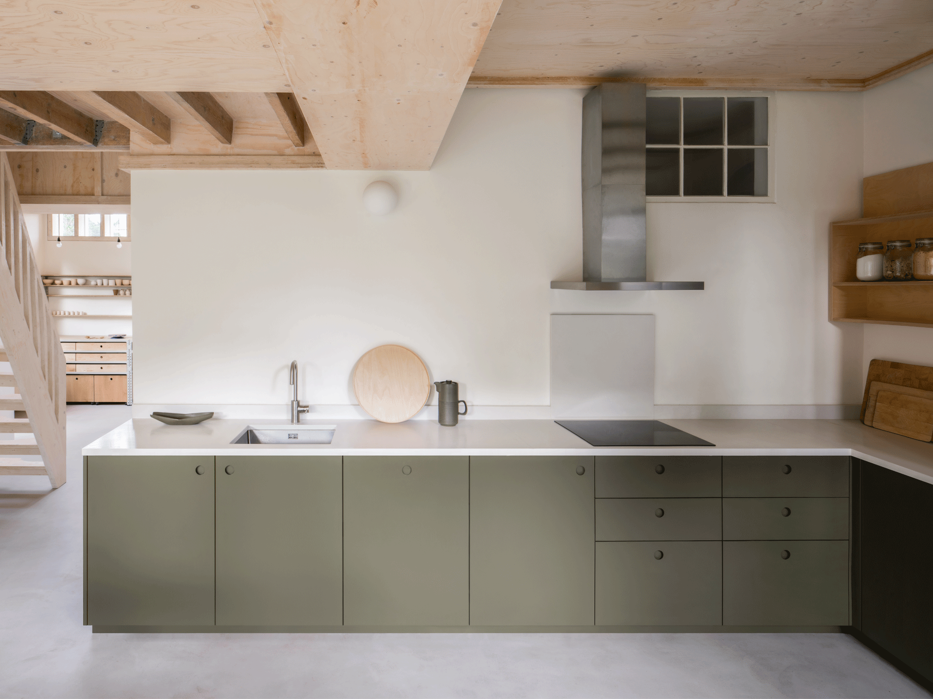 Kitchen with L-shape layout and sage green cabinet fronts