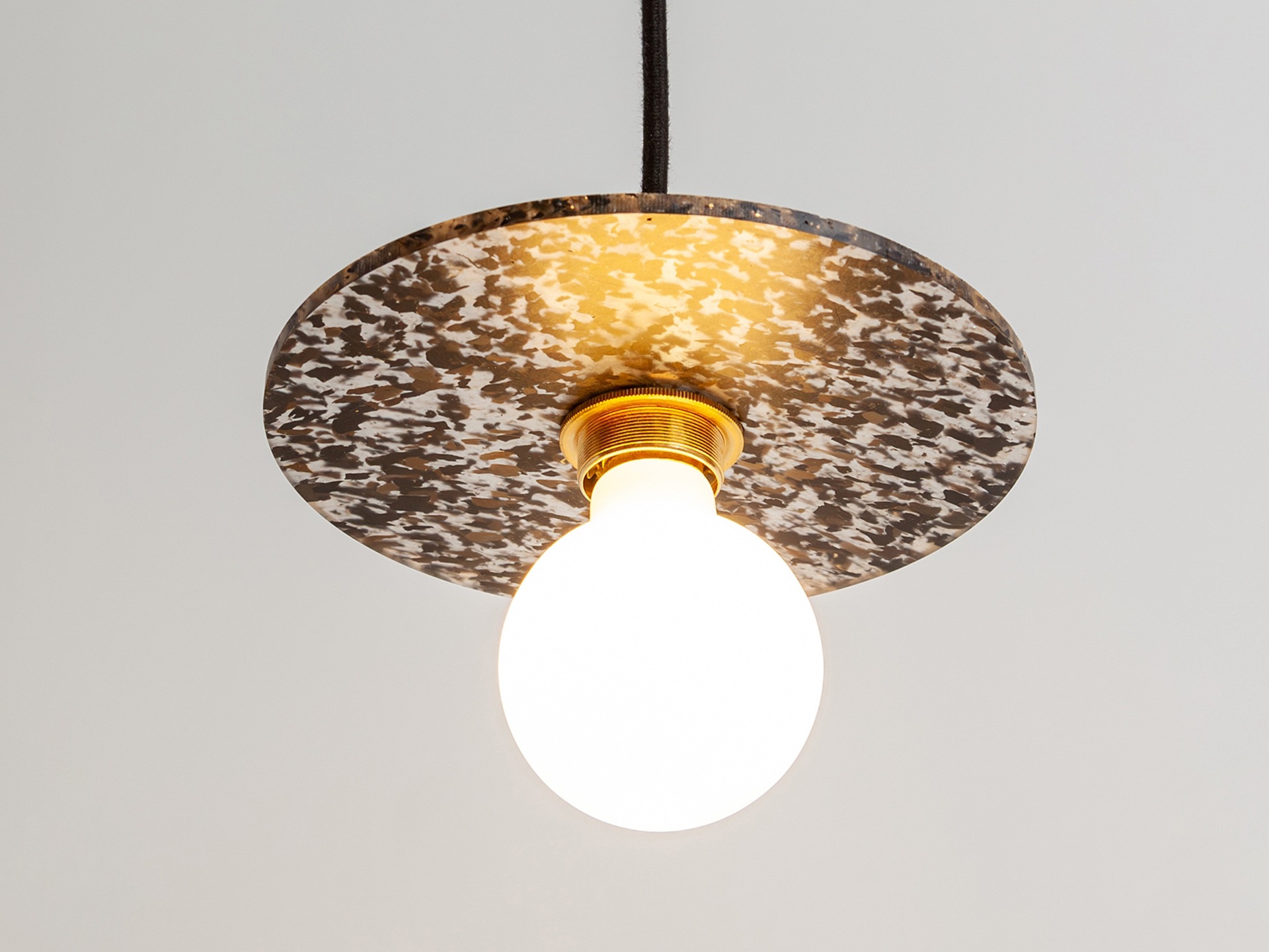 A pendant light made from recycled plastic