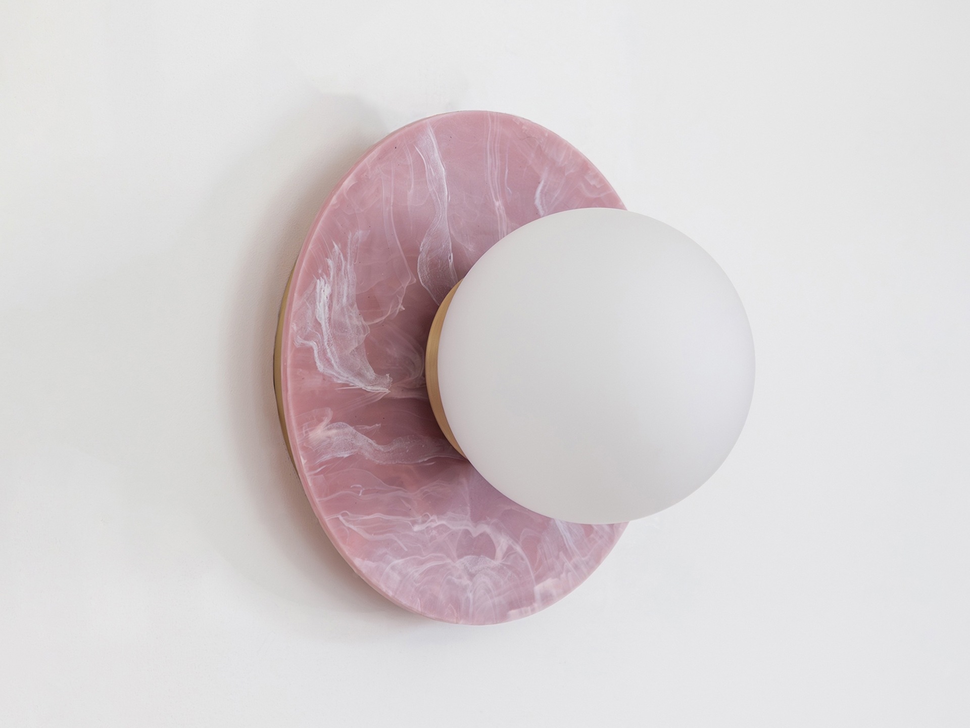 A wall light with a pink marbled recycled plastic base