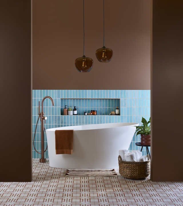 Freestanding bath in matt white with curved top in blue tiled bathroom