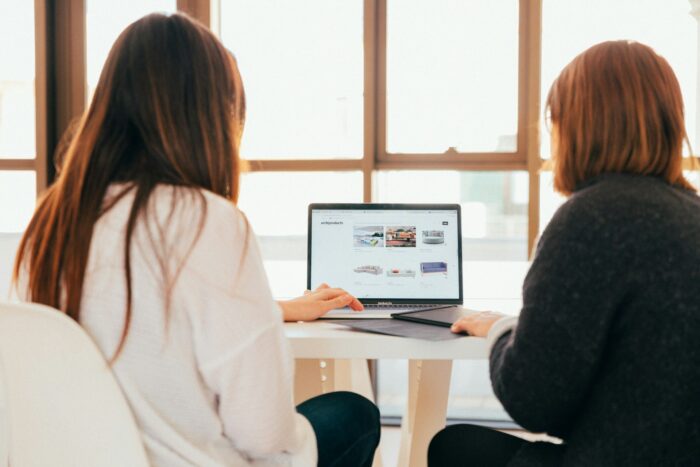 two girls planning looking at computer