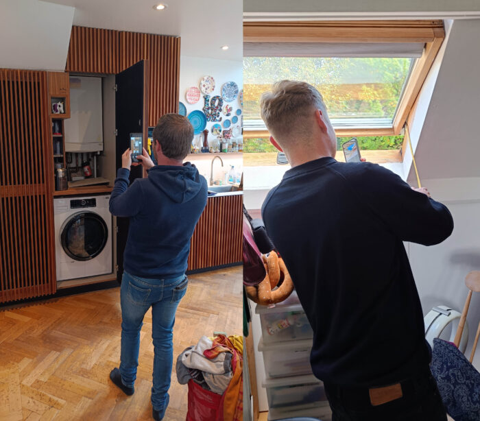 One surveyor takes a photo of a cupboard with a boiler and washing machine in, the other measures the thickness of a loft roof