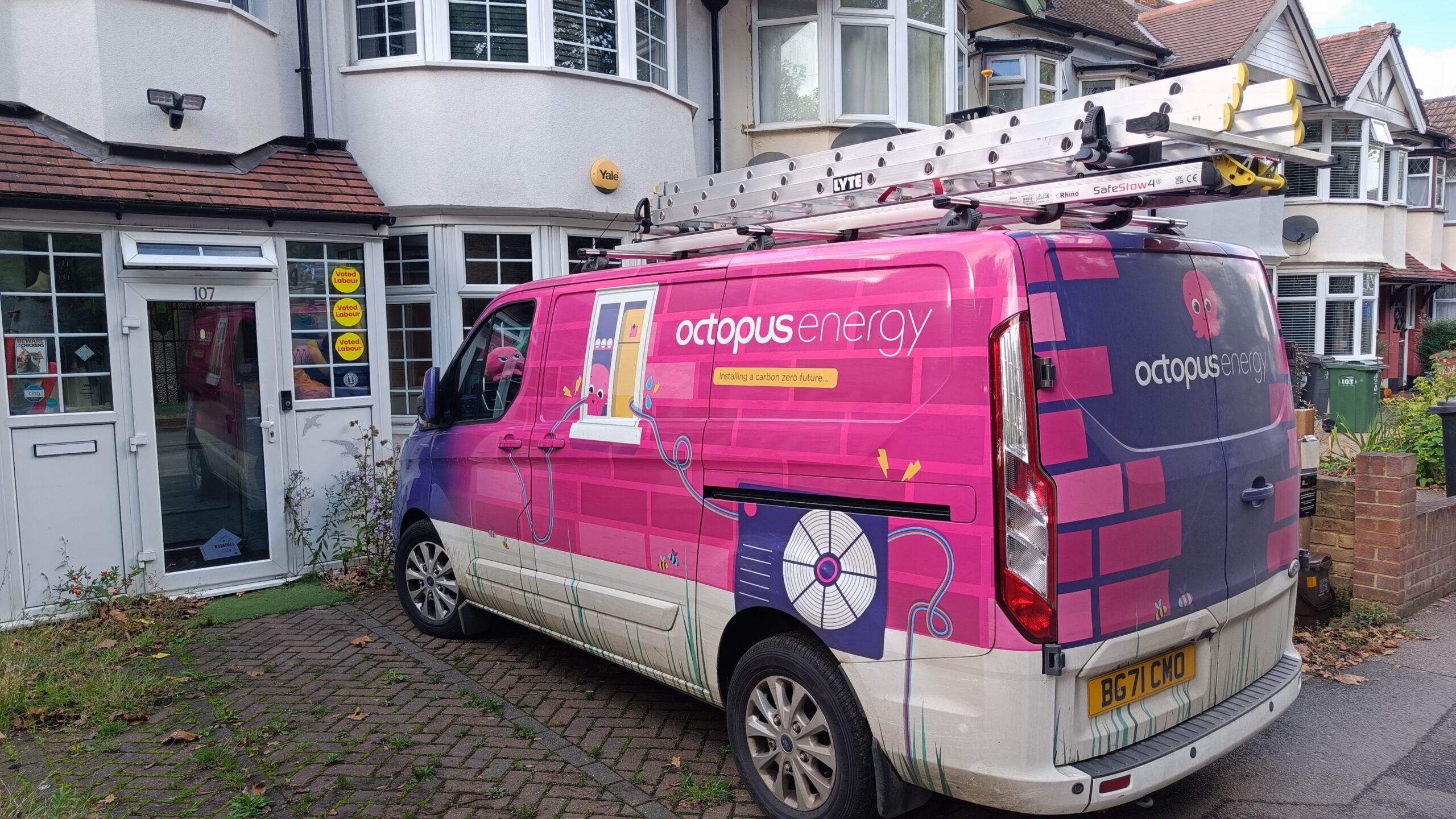 A very pink Octopus Energy van parked in a driveway